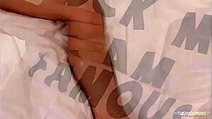 A blonde woman fingers her shaved pussy, strips, and toys herself