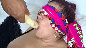 In the quiet kitchen, my horny mother-in-law eagerly sucks my cock with deep passion, her lips wrapped tightly around it.