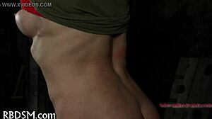 in this intense sadomasochism scene, a dominant figure controls the submissive partner through hardcore acts of pain and pleasure