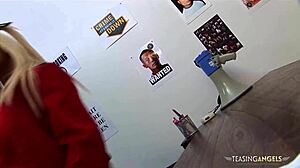 busty blonde interacts with a police officer on the desk