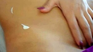 sexy asian girl applies lotion to her body