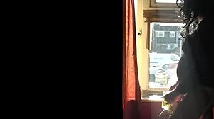 mark wright takes a risk by the window as people walk by outside