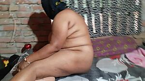 An Indian girl with natural tits sits on a chair, feeling horny as she fingers herself to a powerful orgasm.