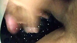 Amateur masturbates big black cock to cum in shower handjob