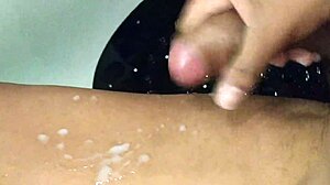Amateur masturbates big black cock to cum in shower handjob