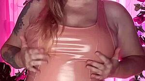 Curvy milf with huge tits and ass teases intensely in latex dress. Showing off natural assets