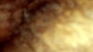 A mature woman with a wet pussy in close-up