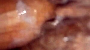 A mature woman with a wet pussy in close-up