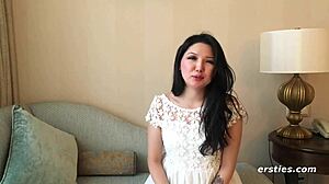 Ameliya lies in the bedroom, fingering her shaved pussy with small tits exposed.