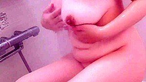 Wow, busty Japanese milf wets pussy in bath masturbation!
