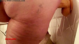 Fat amateur plays with big dildo in bathroom