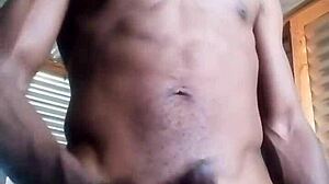 Horny amateur kneels to masturbate big black cock with huge balls