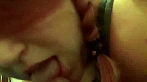 the redhead milf gives him a blowjob while music plays. voyeurs watch the intimate scene unfold