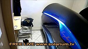 Blonde milf fingers pussy in public solarium spied on webcam