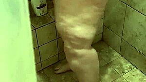 She's washing up in the shower, enjoying the bath