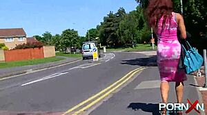 In the outdoor wilderness, a redhead ebony goddess with tattoos flashes her nude body and indulges in public pissing fetish