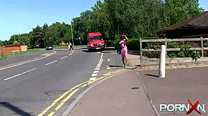 In the outdoor wilderness, a redhead ebony goddess with tattoos flashes her nude body and indulges in public pissing fetish