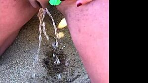 my wife peeing on the beach for a long time