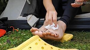 I wipe my dirty feet with a napkin while camping with my mother in law