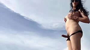 damn, look at this sexy hot ladyboy stroking her monster cock on a white sand beach!