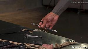 Inked black master torments bound brunette slave.