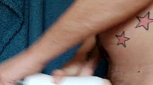 Gay tattooed guy wanks cock in kitchen