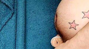 Gay tattooed guy wanks cock in kitchen