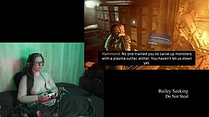 this naked brunette is playing deadspace, big tits on display
