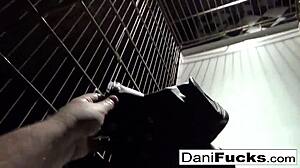 I admire sexy Dani Daniels posing in a cage, feeling her playful allure.