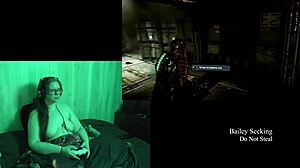 this naked brunette is playing deadspace, big tits on display