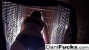 I admire sexy Dani Daniels posing in a cage, feeling her playful allure.