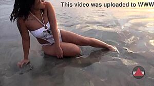 Enjoying a messy beach day with wet bikini