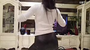 michiel dances in perfect leather pants showcasing her chinese curves