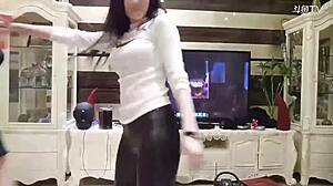 michiel dances in perfect leather pants showcasing her chinese curves