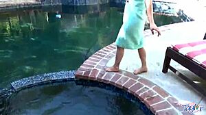 blonde teen relaxes with toys in the outdoor pool
