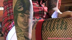 Bold punk goth shows small tits and tattoos in fetish photoshoot.