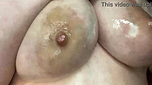Sexy bbw woman massages her big natural tits with oil.