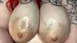 Sexy bbw woman massages her big natural tits with oil.