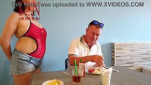 Naked waitress serves food in her navel at work