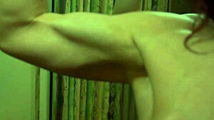 busty redhead milf flexes muscles seductively in mirror