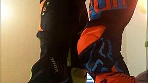 This gay dude gives a motocross blowjob in fetish costumes.