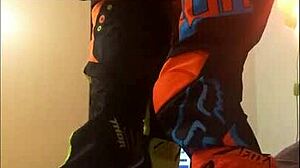 This gay dude gives a motocross blowjob in fetish costumes.