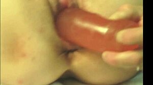 Milf fucks herself with red dildo