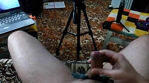 Couple performs intense handjob on huge cock with clothespins, leading to massive cumshot.