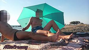 Look at me flashing my cock on a public beach with stepdaughter helping