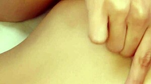 Cute brunette reveals her petite body on the sofa.