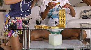 Eva Isabel and Chrissy play Jenga, flashing upskirt at home.