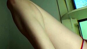 Pixie showcases red lingerie in a photoshoot setting