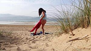 Curvy brunette MILF strips naked and works out on the beach