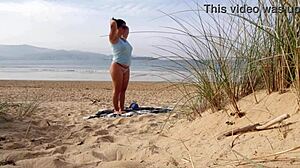 Curvy brunette MILF strips naked and works out on the beach